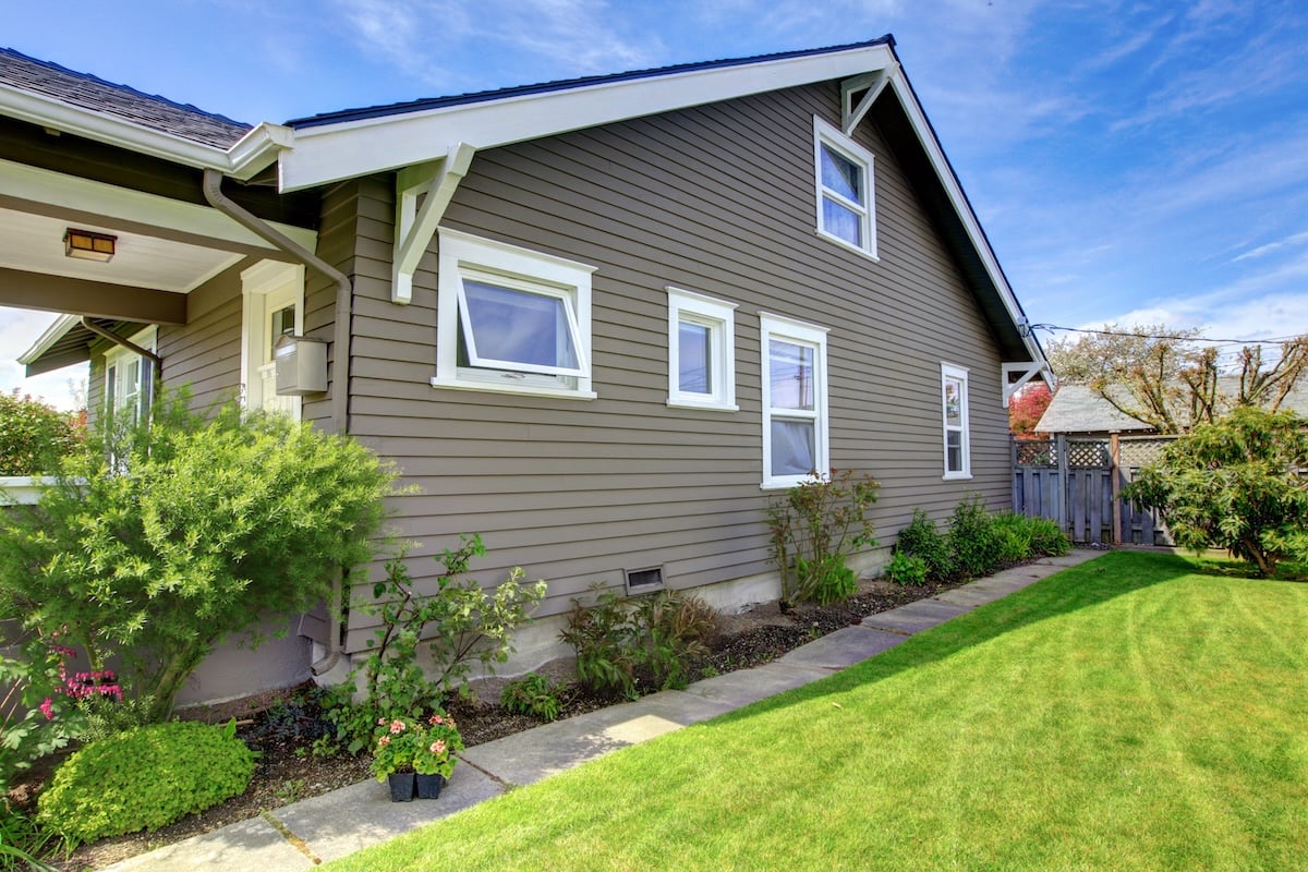 Side view of a house with brown horizontal siding