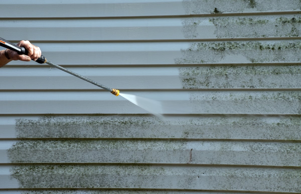 Cleaning the mold from the vinyl siding on this exterior wall