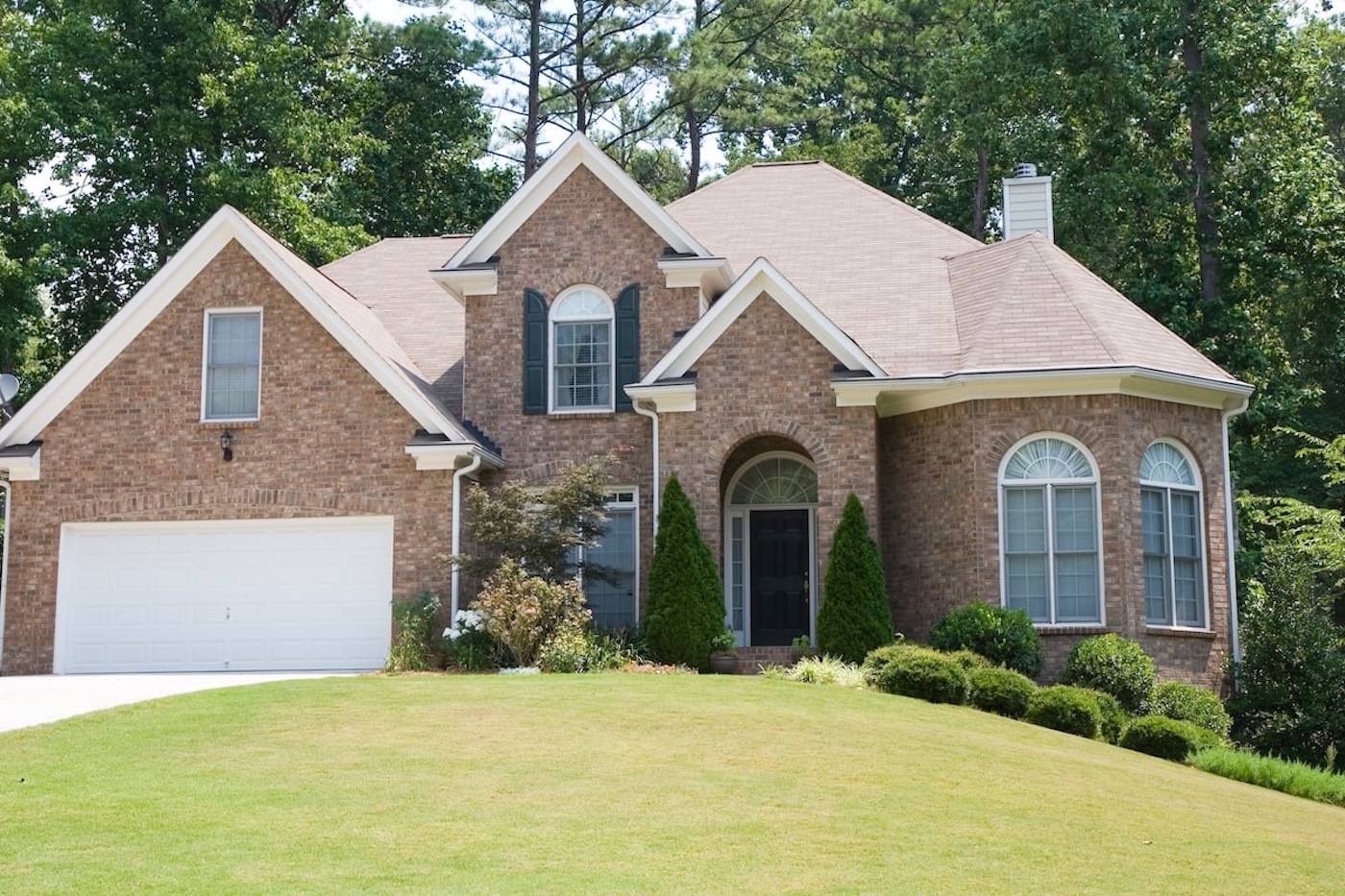 Exterior of new home on bright sunny day with blue sky