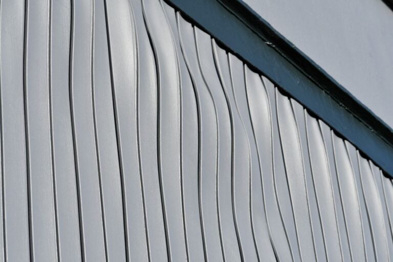 warped siding light grey house