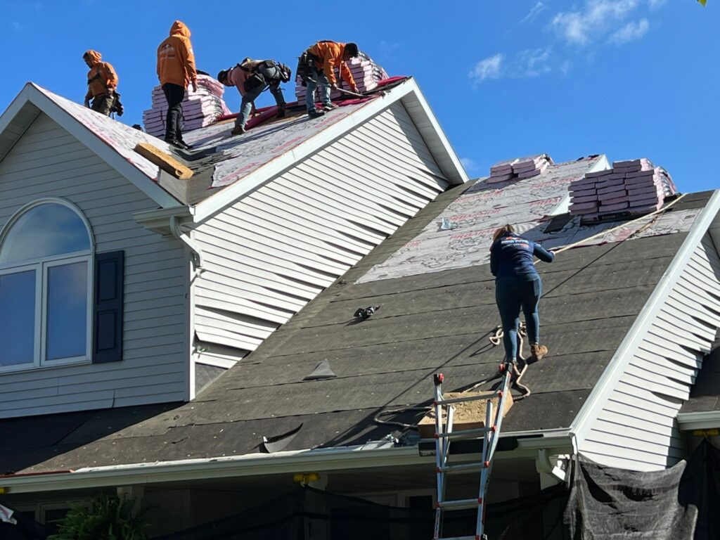 Vanguard team working together on a roof