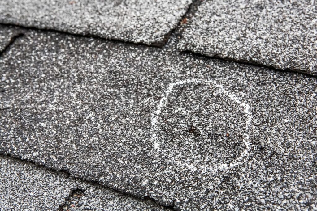 close-up view of shingle damage after hail storm