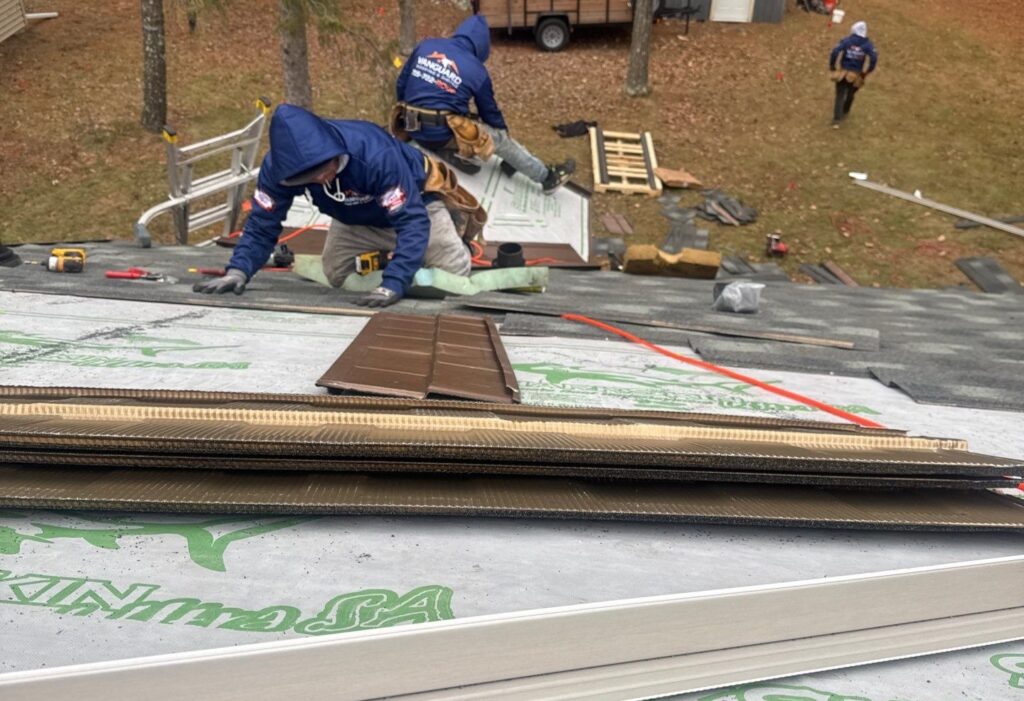 Vanguard team working and installing shingles on a roof