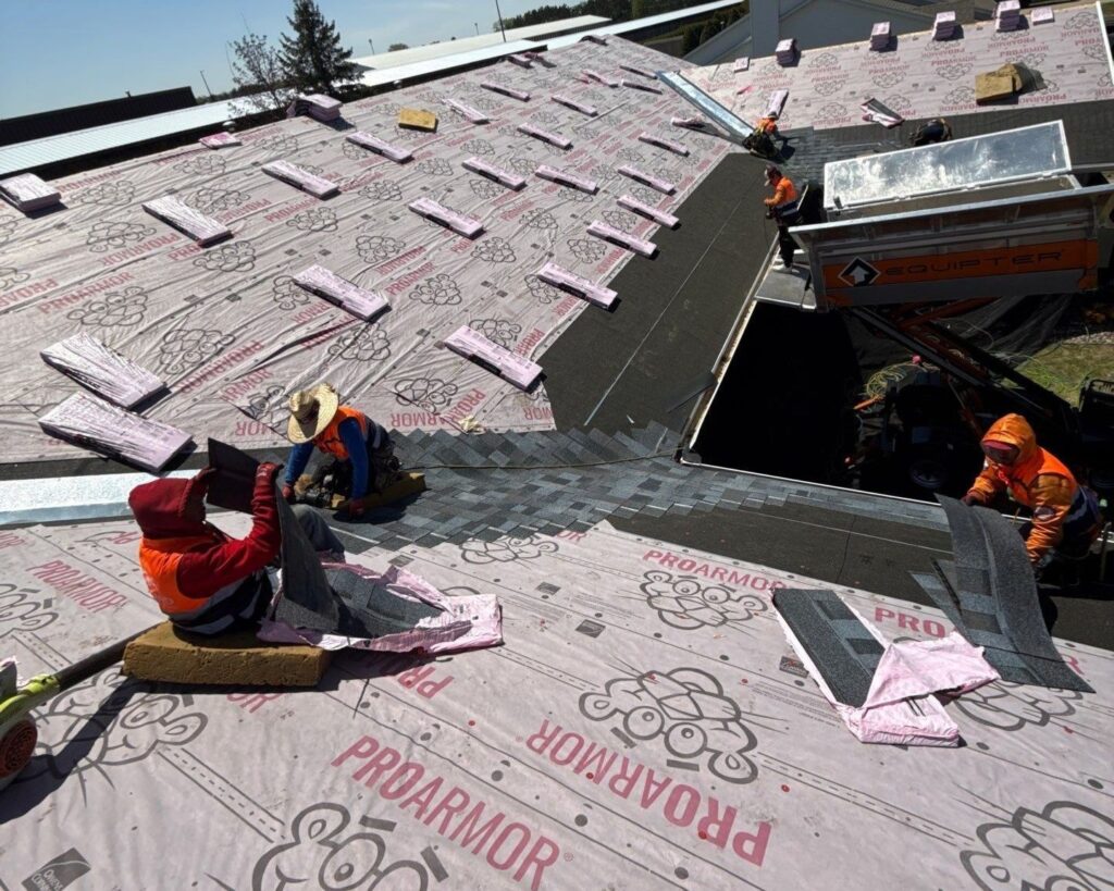 Vanguard team installing shingles on a roof