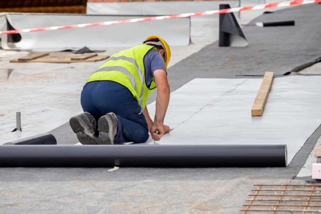 roofers preparing commercial roof material