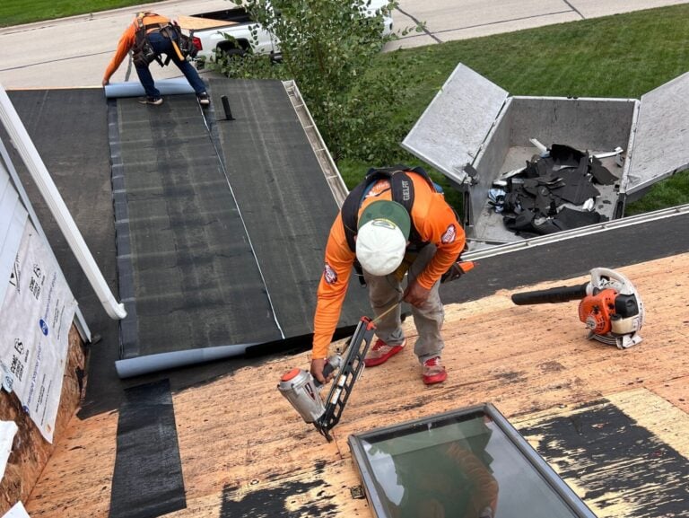 roof restoration workers installing new roof