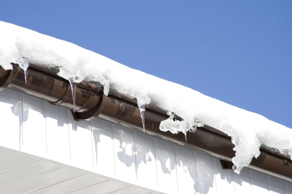 Roof and gutters covered in snow