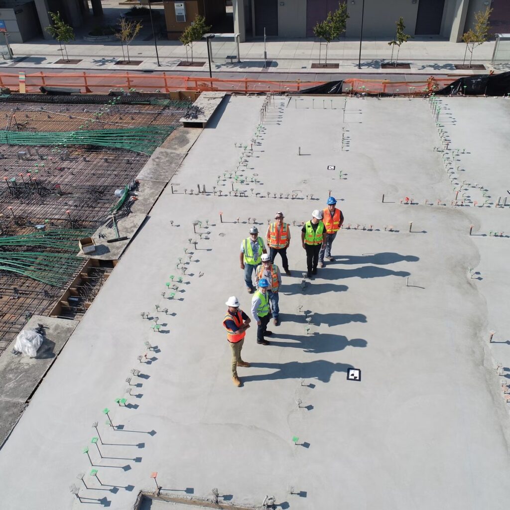 Construction professionals inspecting a large commercial roof for a roofing company near me