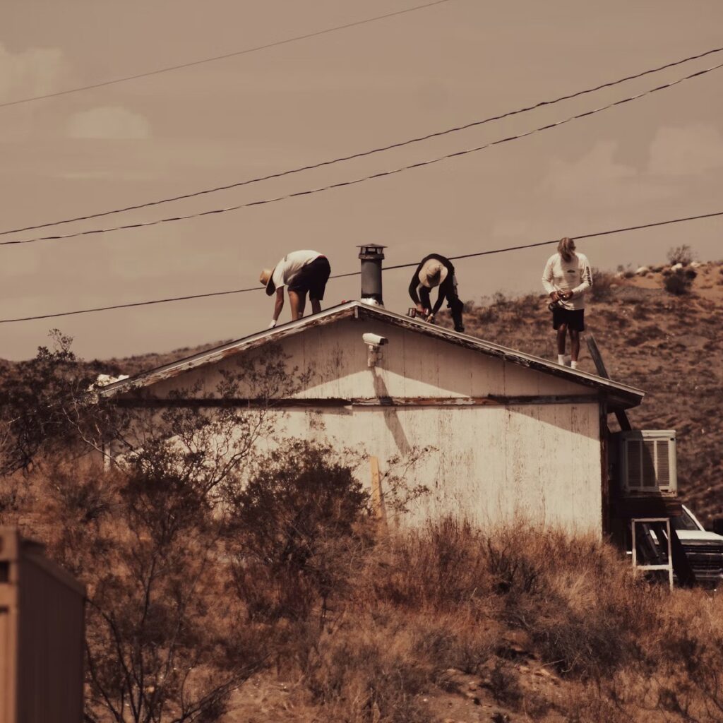 Roofing professionals working on a residential roof for a roofing company near me