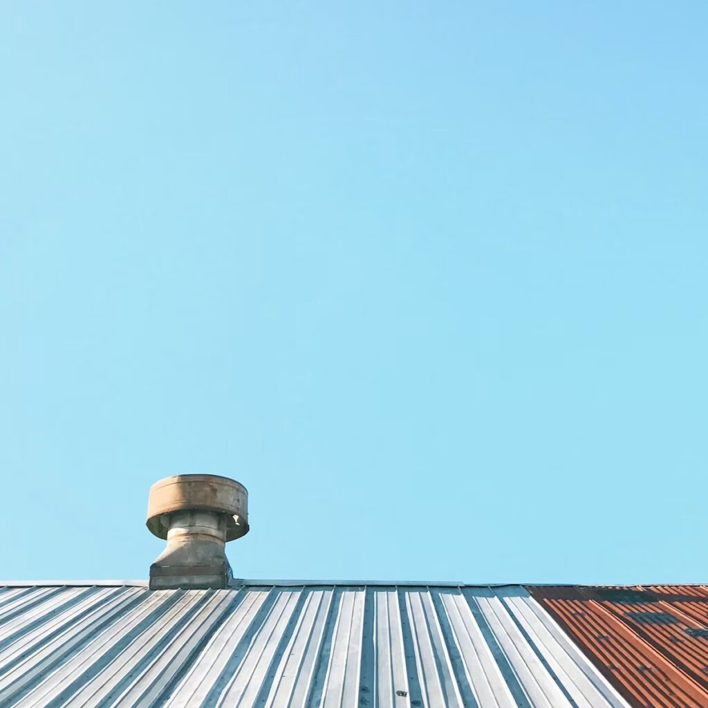 Commercial metal rooftop with ventilation system for a roofing company near me