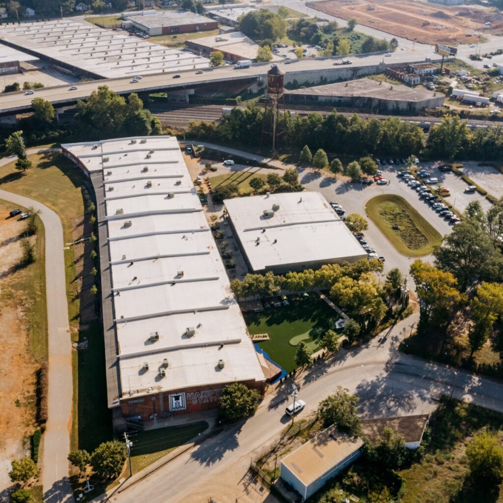 Aerial view of large commercial flat-roof buildings for a roofing company near me