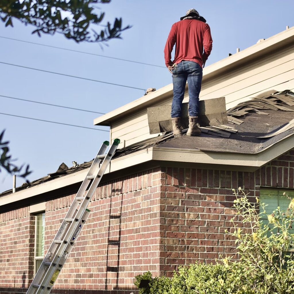 Roofing professional inspecting damaged shingles on a residential home for an experienced roofing company in Lisle, IL