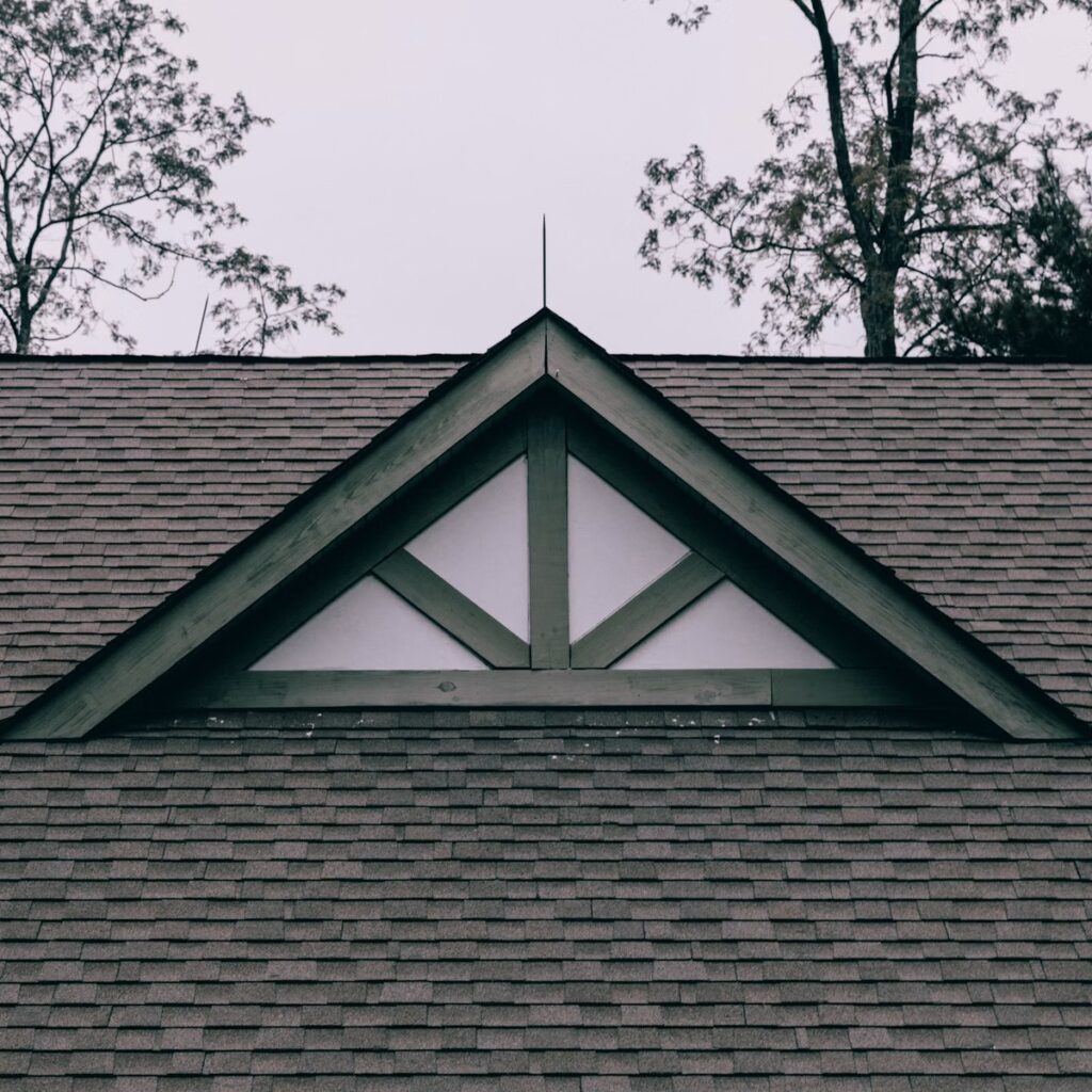 Residential shingle roof with a prominent gable for a roofing company near me