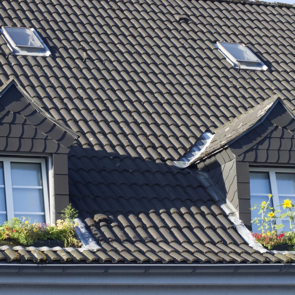 Tile roof with skylights and dormer windows for a roofing company near me