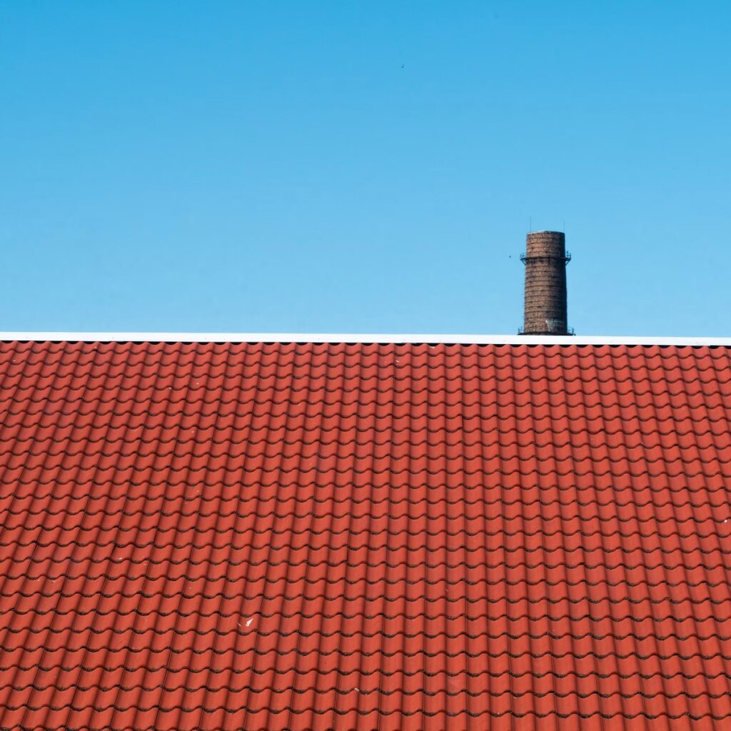 Red tile roof under a clear sky for a local roofing company in Homer Glen, IL